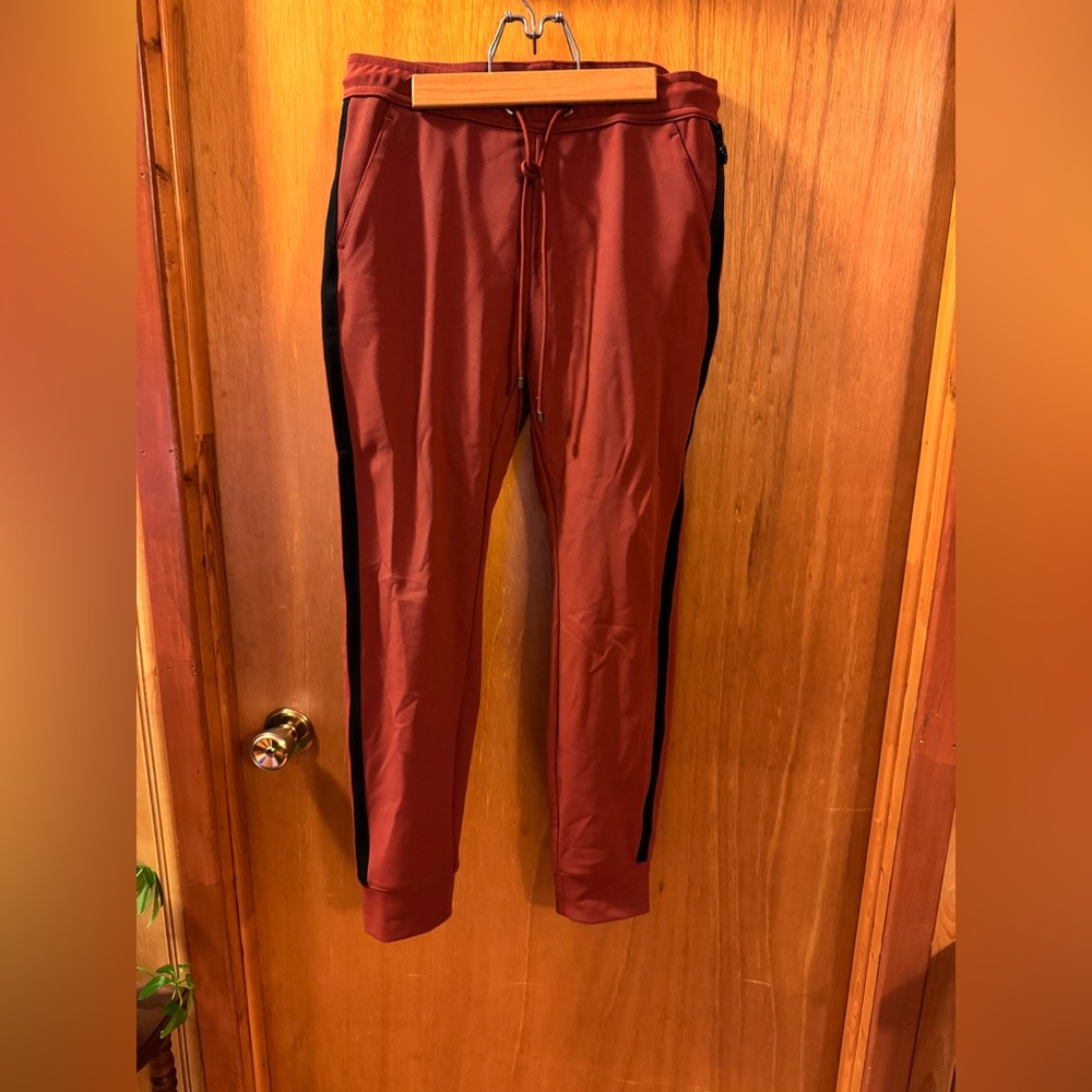 MAC
Women’s Rust Jogger Pants with Black Stripes and zippers.